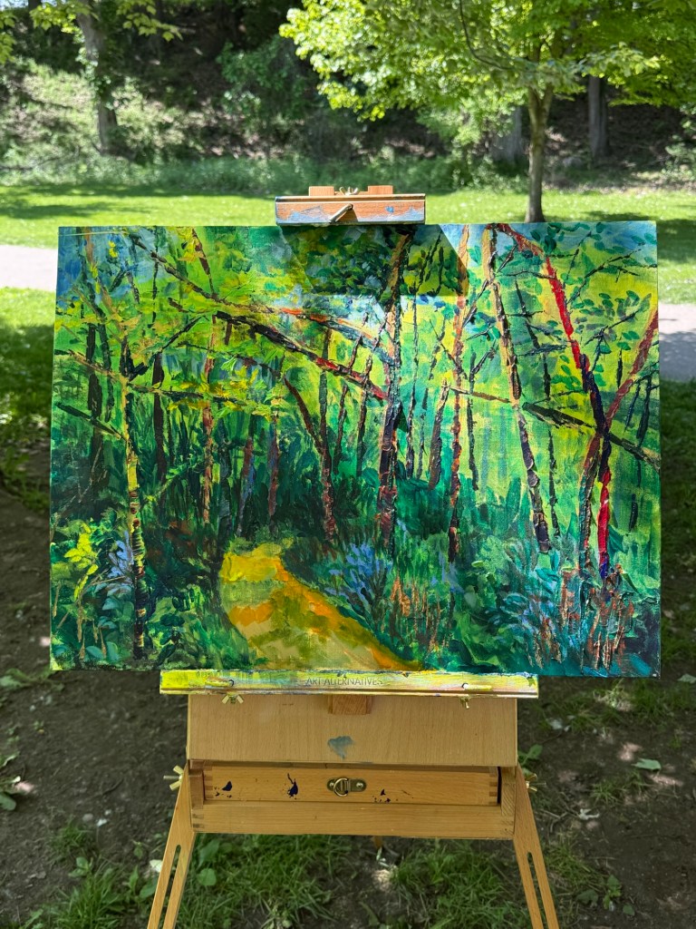 Acrylic painting of a path through the woods in greens, yellows and blues.